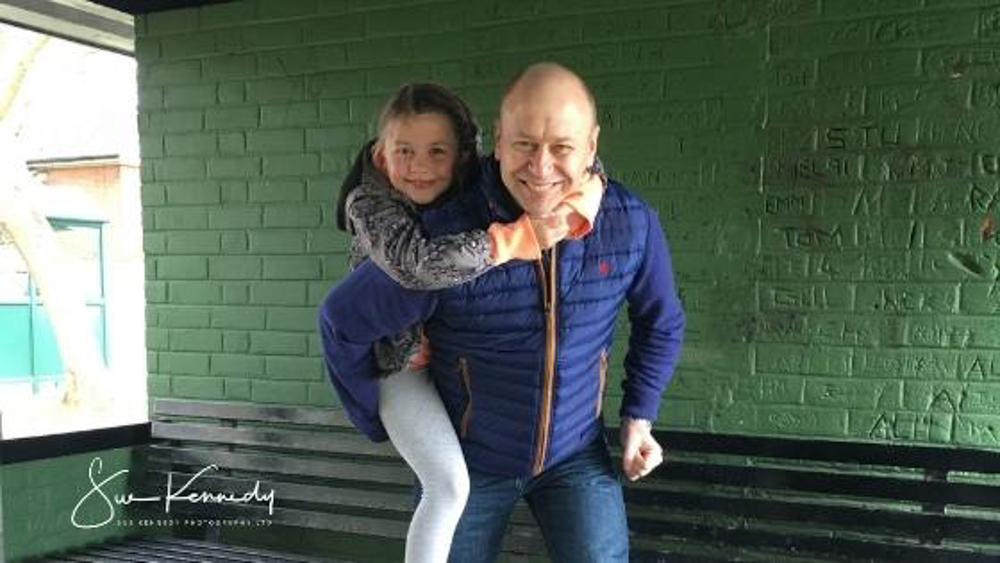 little girl having a piggy back ride with her father