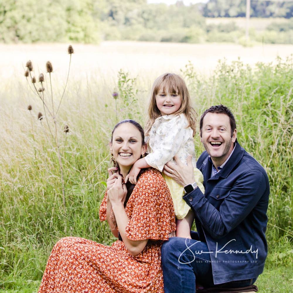 Outdoor family photography with parents and 4 year old in grasses