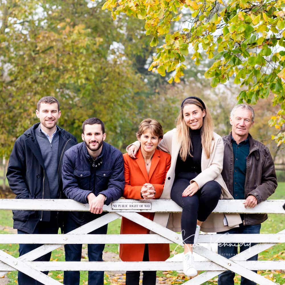 Family portrait of two generations sat on a the gate with autumn colours behind using the grounds at my studio in Harlow, Essex.