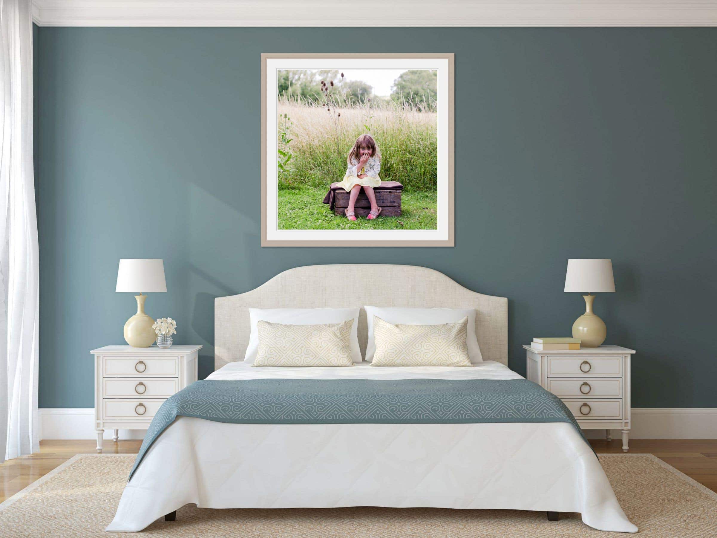 room scene show casing a framed photo over a double bed