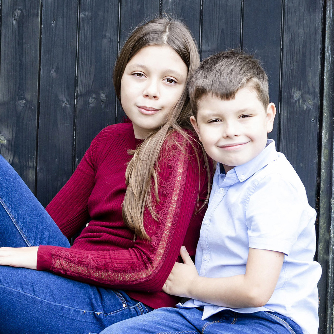 Outdoor family photography of two siblings sat down