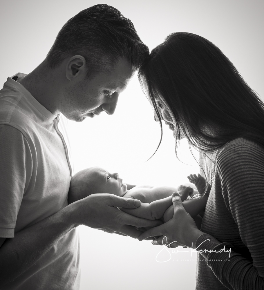 classic image of parents holding their new baby in black and white