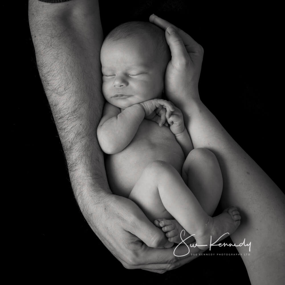 baby in parents arms