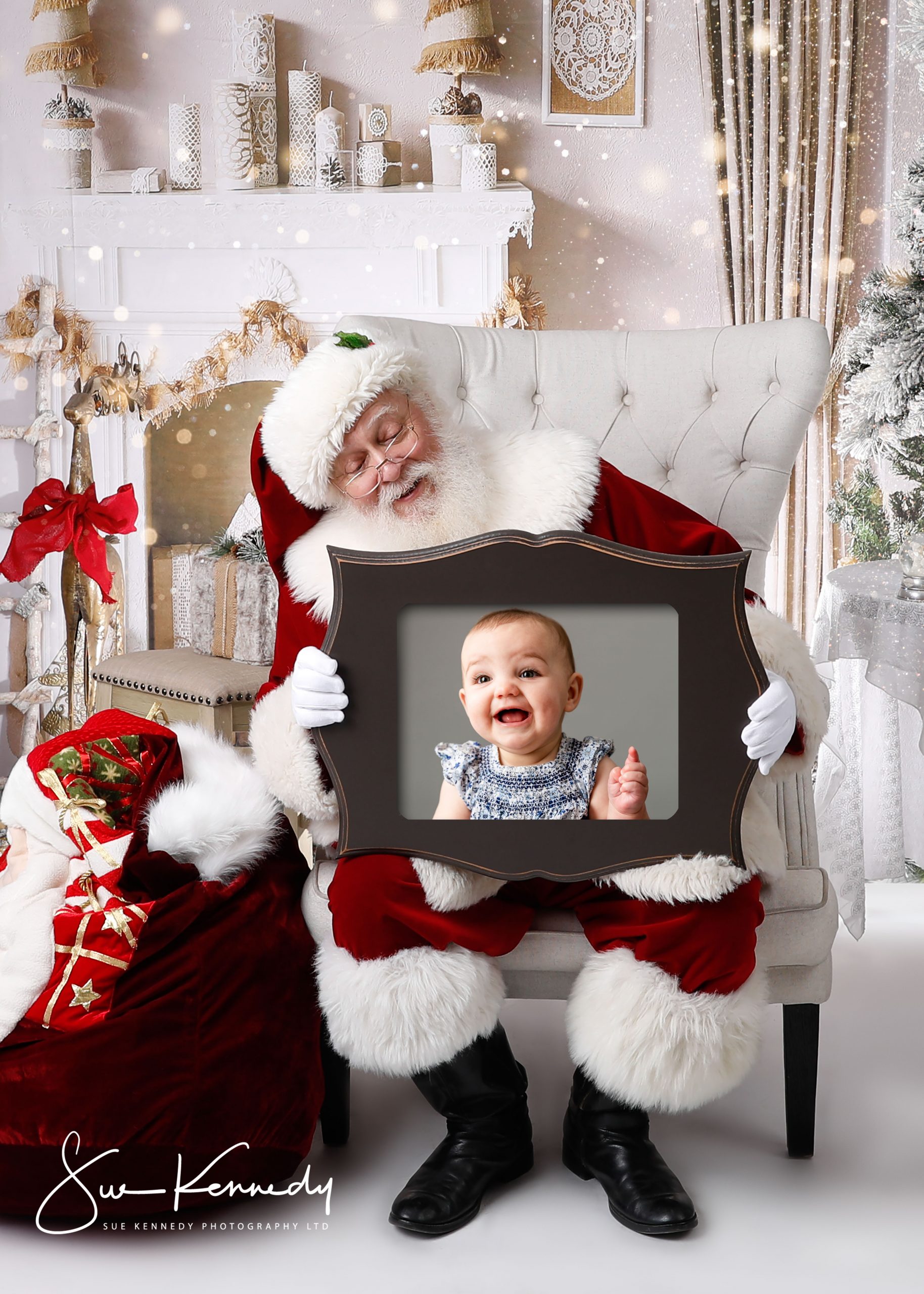 Santa holding a frame with baby's image in