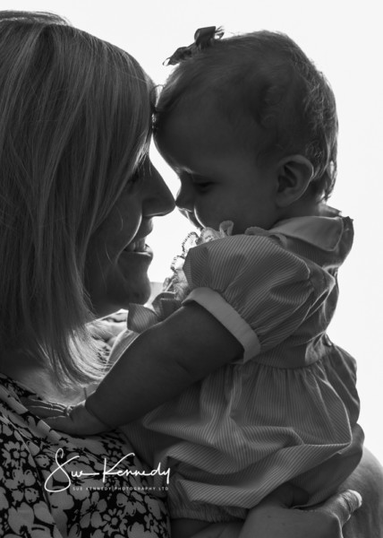 Tender black and white mother and baby portrait showing genuine connection and intimacy - natural mother and child portrait photography Sue Kennedy Harlow Essex