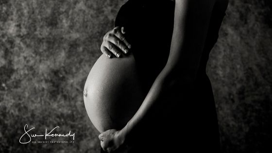 Black and white photography of a pregnant bump cradle my Mum to be's hands