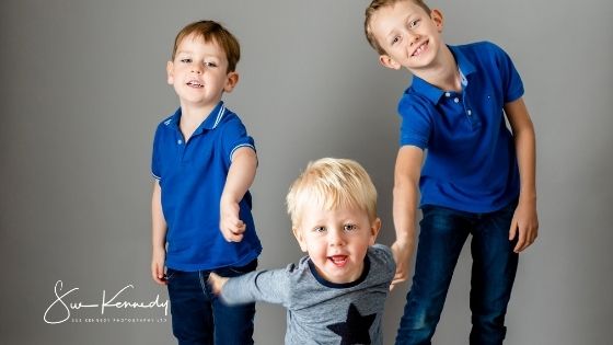 toddler boy photographed with his siblings
