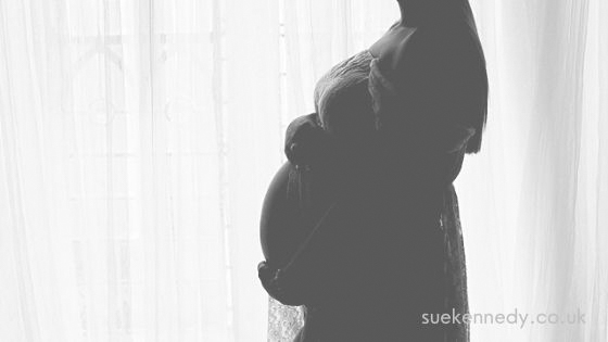 Belly silhouette against a window in black & white