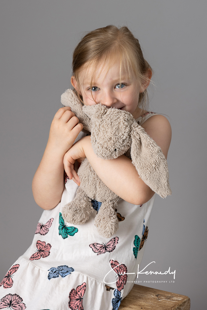 KATTB-4375 Young girl sat photographed peeking from behind her soft toy bunny