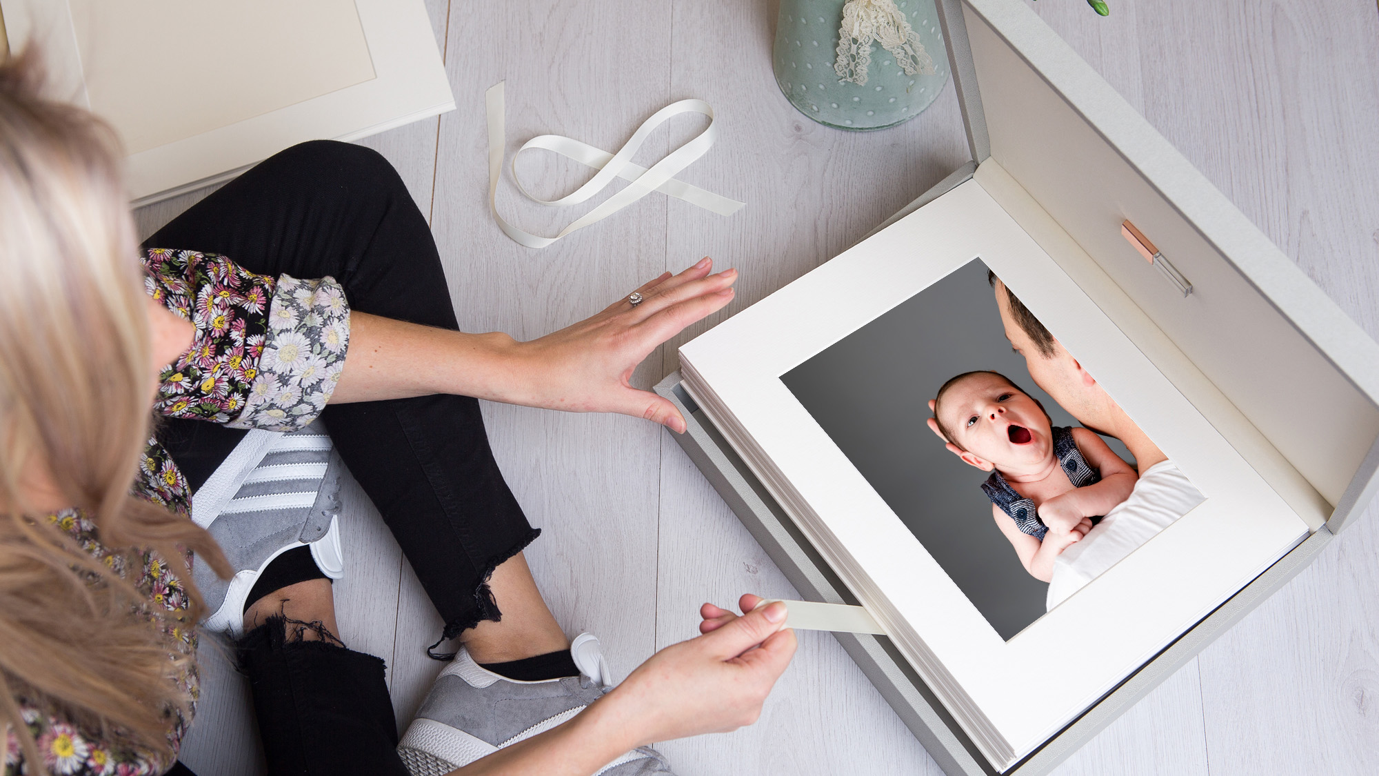 photographed from above of a woman open up a portrait box of prints