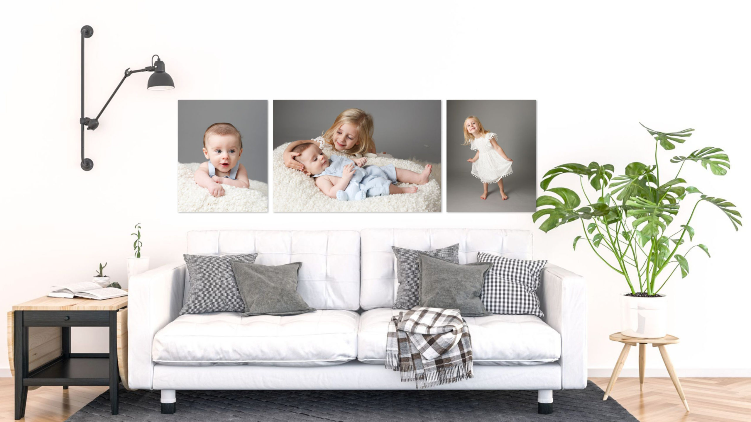 Living room interior displaying photography artwork of family portraits with baby and sibling in situ