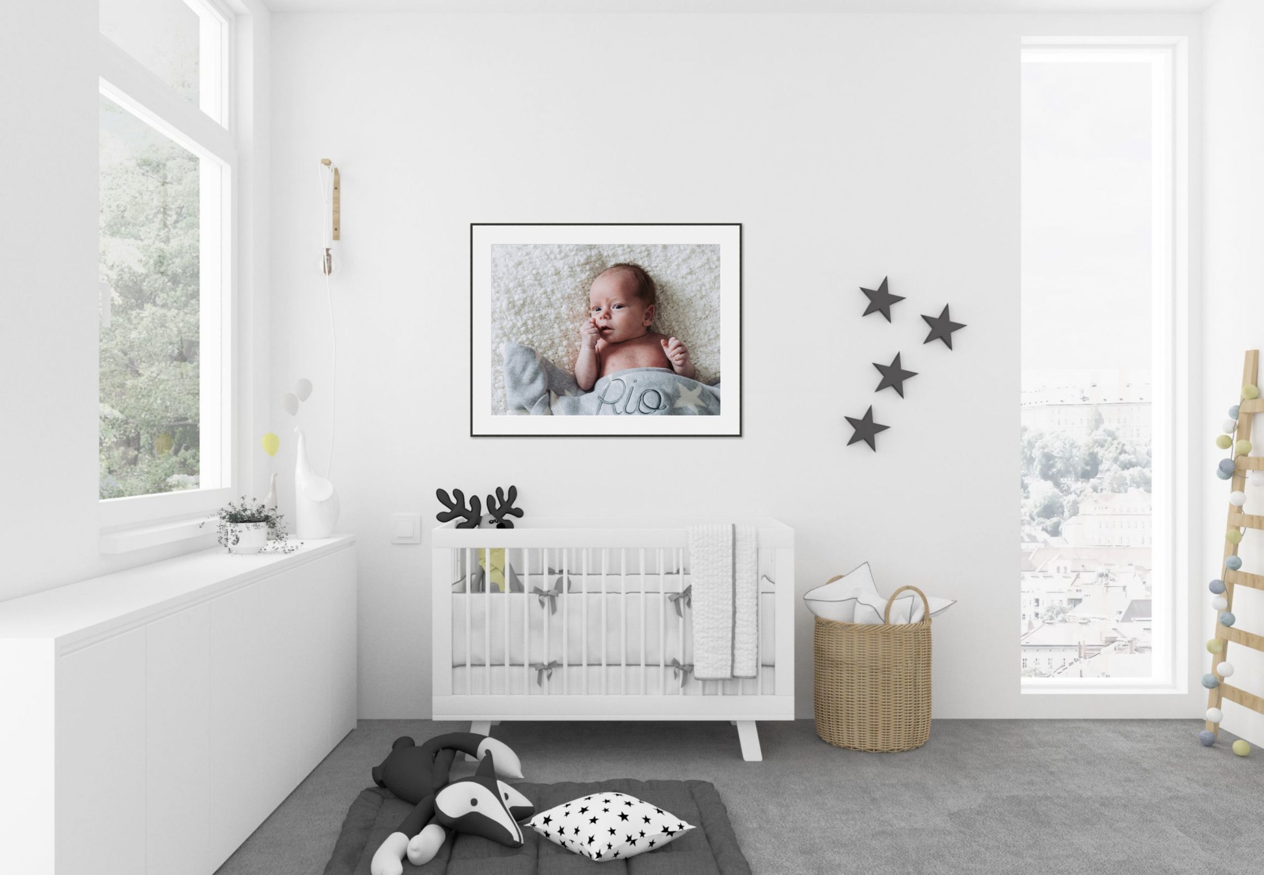 white and grey baby room interior displaying photography artwork of young baby portraits in situ