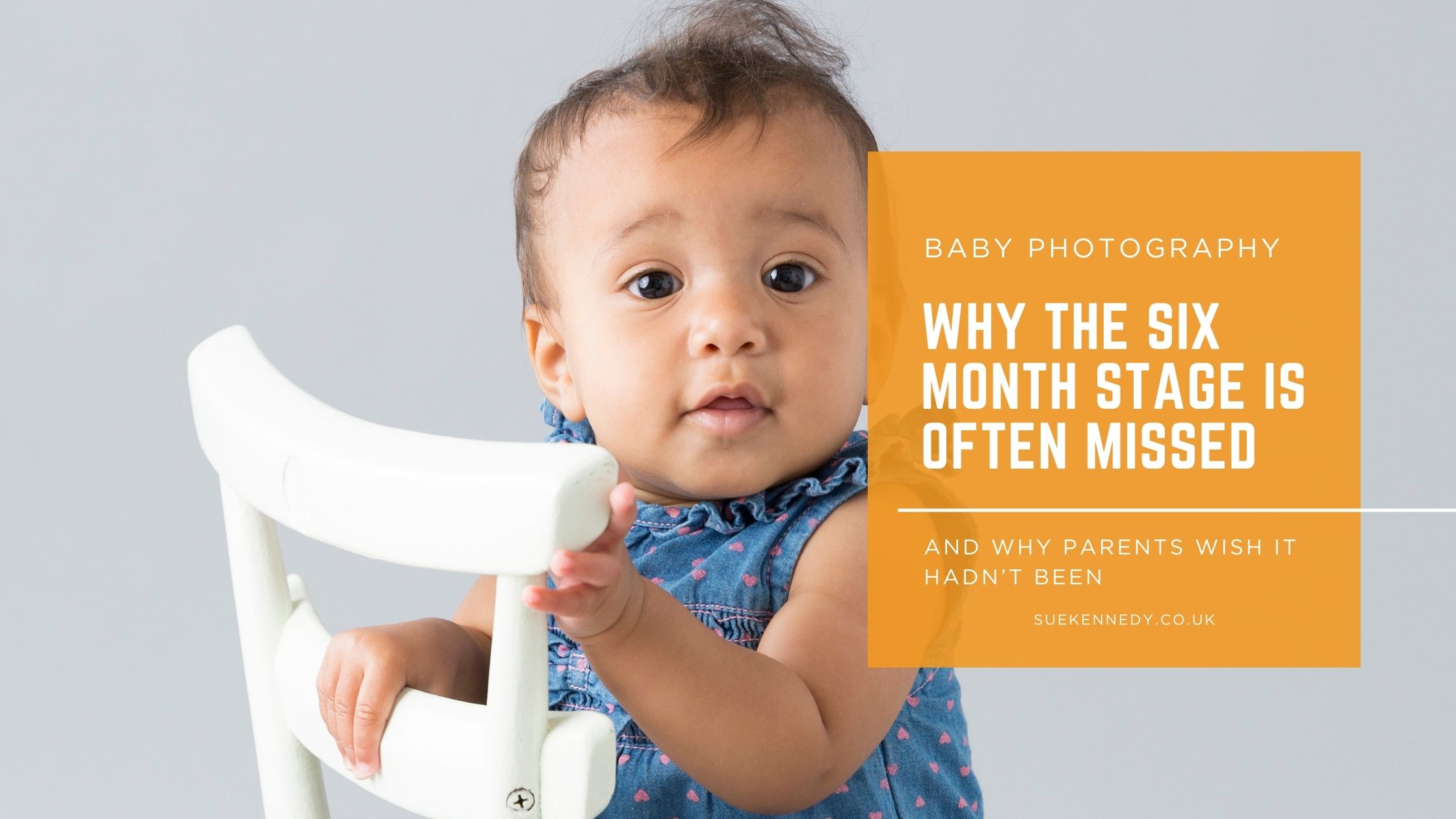 Six-month-old baby sitting confidently on a small white chair during a baby photography session, showing curiosity and personality